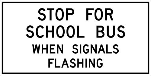 Stop for school bus sign, a white rectangle with black letters reading STOP FOR SCHOOL BUS WHEN SIGNALS FLASHING